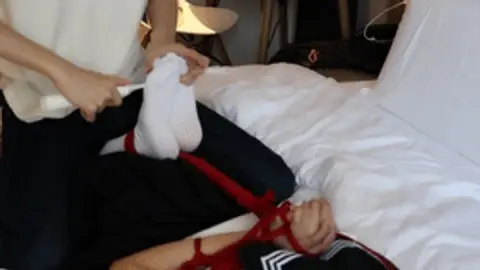 A cute twin-tailed JK girl was tied to the bed and had her white-stockinged feet tickled with props.