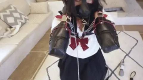 mz14 - A puppy dressed in JK clothes is restrained and whipped.